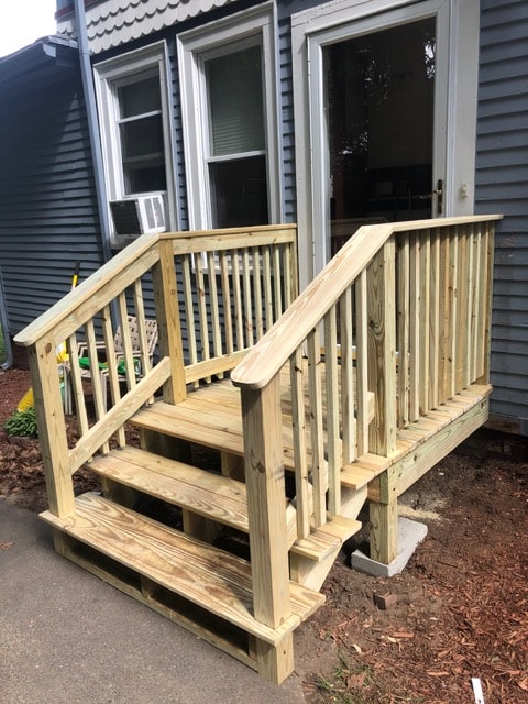 Completed exterior wood steps, landing, and railings